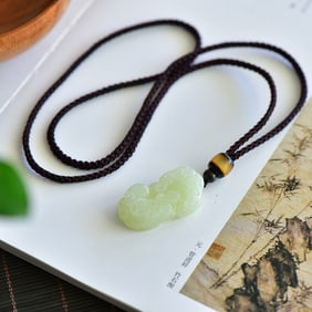 An Exquisite White Jade Auspicious Beast Pendant