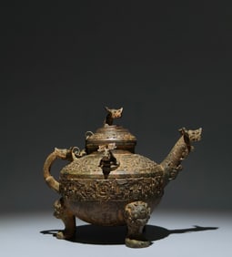 An Archaic Bronze Hollow Feather Pattern Beast-head Tripod Food Vessel,With Inscription