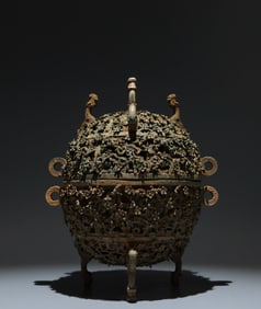 An Archaic Bronze Hollow Plum Blossom Pattern Tripod Food Vessel,With Inscription