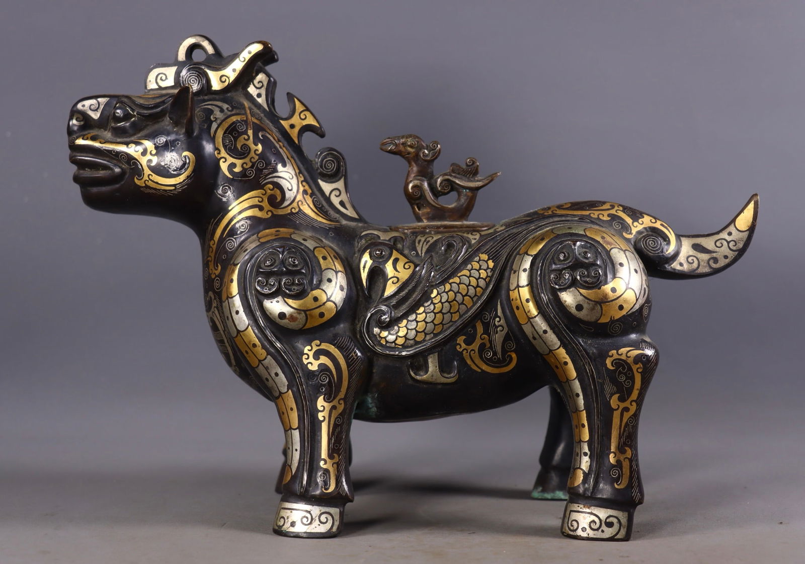 A Rare Bronze Inlaid Gold and Silver Auspicious Beast-Shaped Zun (1 of 9)