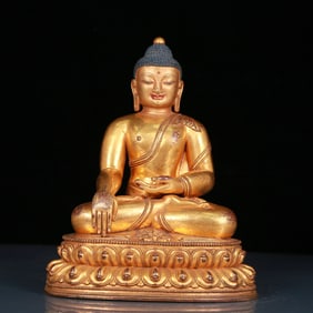 A solemn gilt bronze statue of Sakyamuni