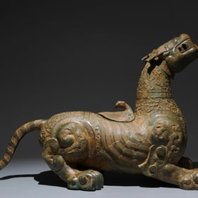 An Archaic Bronze Auspicious Beast Ornament,with Inscription