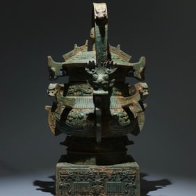 An Archaic Bronze Phoenix Pattern Loop-handled Pot