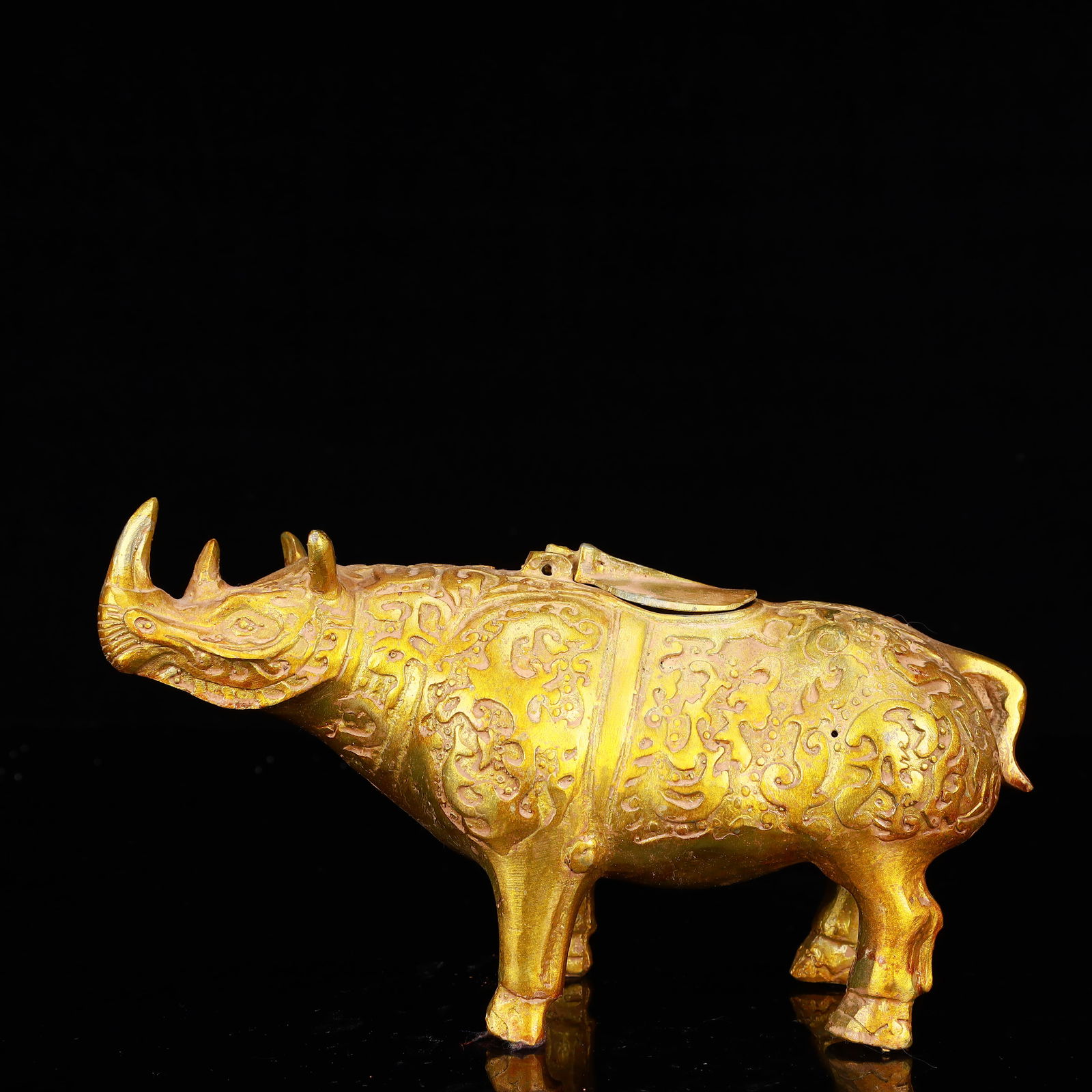 A Rare Gilt Bronze Rhinoceros Zun: A Rare Gilt Bronze Rhinoceros Zun,The Warring States period in China,Size:8.7inx2.8inx5.1in,Weight:950g 