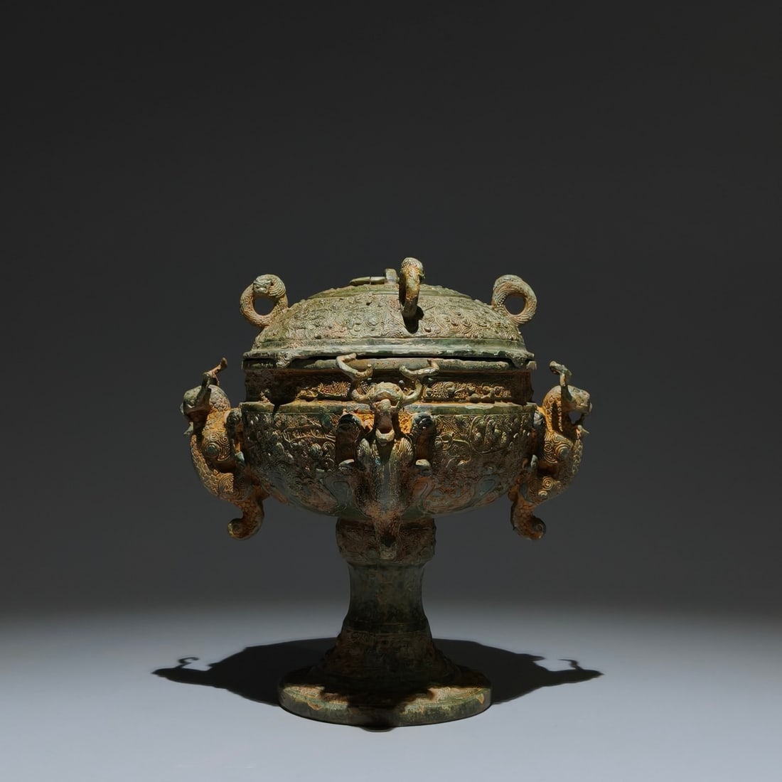 An Archaic Bronze Phoenix Pattern Dragon-Ears Ritual vessel,with Inscription: An Archaic Bronze Phoenix Pattern Dragon-Ears Ritual vessel,with Inscription,The Warring States Period in China,Size:7.9inx7.5inx5.1in 青铜凤纹龙耳礼器,