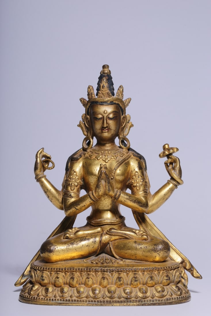 An Exquisite Gilt Bronze Four-arms Statue of Avalokitesvara: An Exquisite Gilt Bronze Four-arms Statue of Avalokitesvara Qing Dynasty, China Size:5.5inx4.7inx3in Weight:789g铜鎏金四臂观音坐像