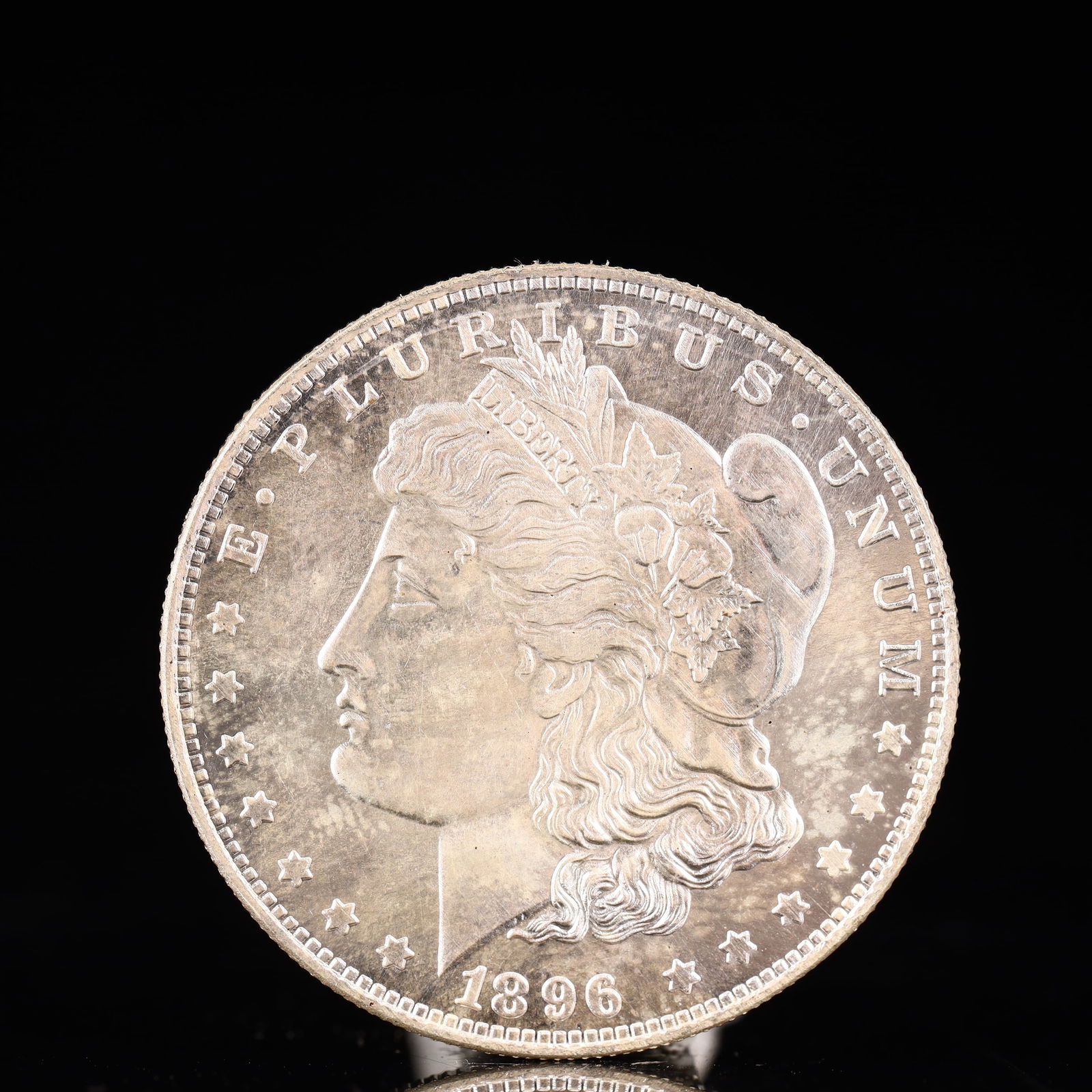 USA Morgan Dollar 1896 Coin: Obv: profile bust with date below and E PLURIBUS UNUM legend and stars around. Rev: eagle with In God we trust above within wreath with UNITED STATES OF AMERICA ONE DOLLAR legend. IN GOD WE TRUST / LI