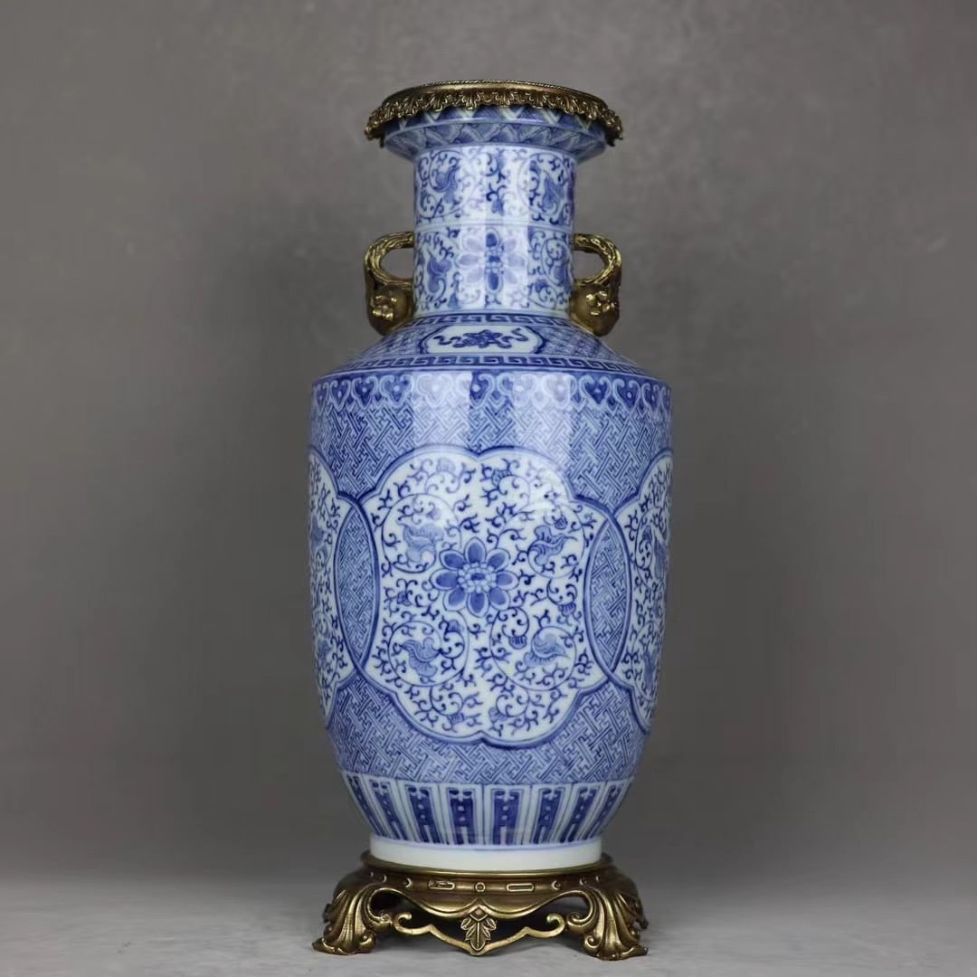 An Exquisite Blue and White Inlaid Bronze Lotus Pattern Double-Ears Vase: An Exquisite Blue and White Inlaid Bronze Lotus Pattern Double-Ears Vase Qing Dynasty, China Qianlong Six-character Mark Size:20.3inx8.3in青花花卉镶铜石઒