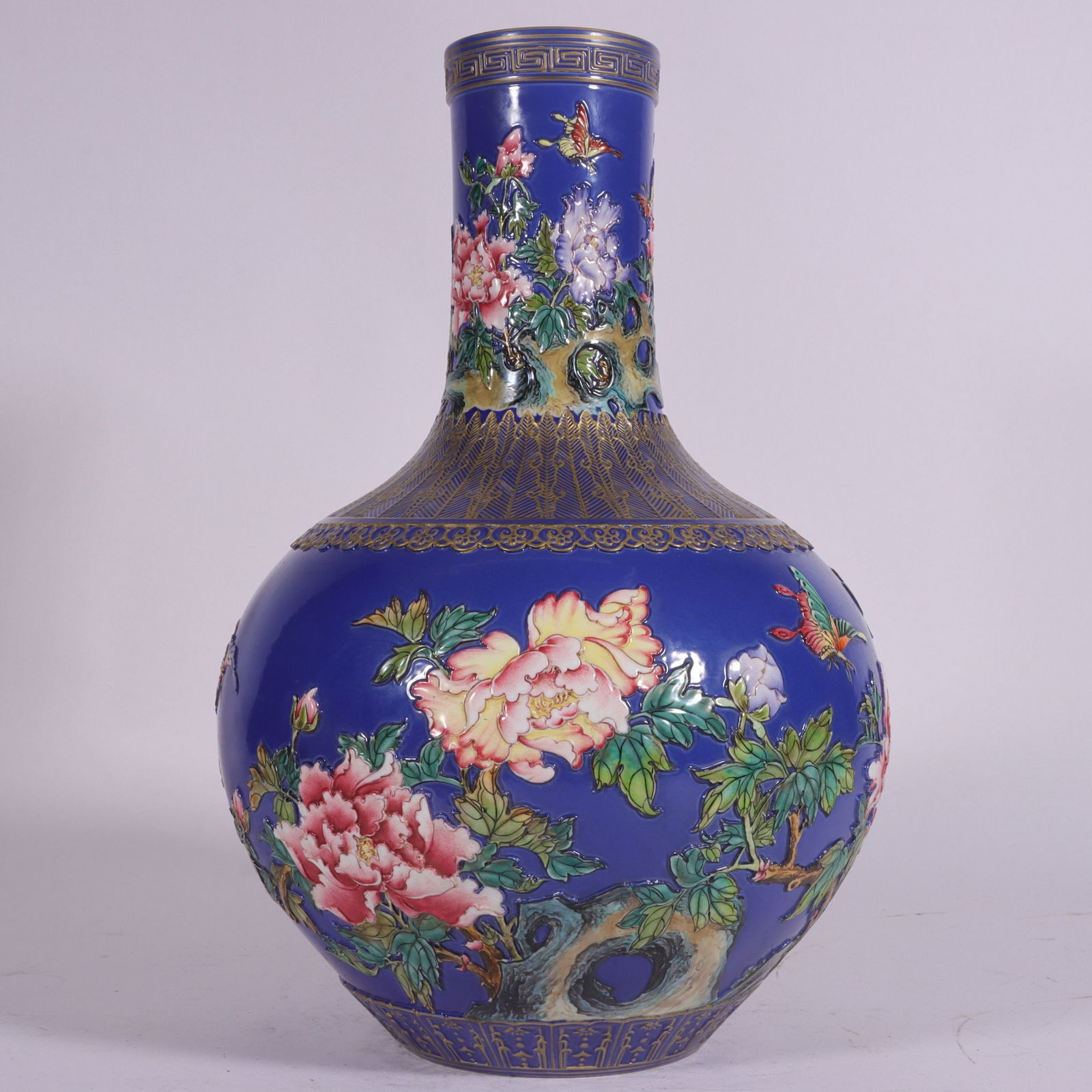 An Exquisite Enamel Flower and Butterfly Pattern Vase: An Exquisite Enamel Flower and Butterfly Pattern Vase Qing Dynasty, China Qianlong Six-character Mark Size:13.3inx7.9in珐琅彩蓝地雕刻花卉天&