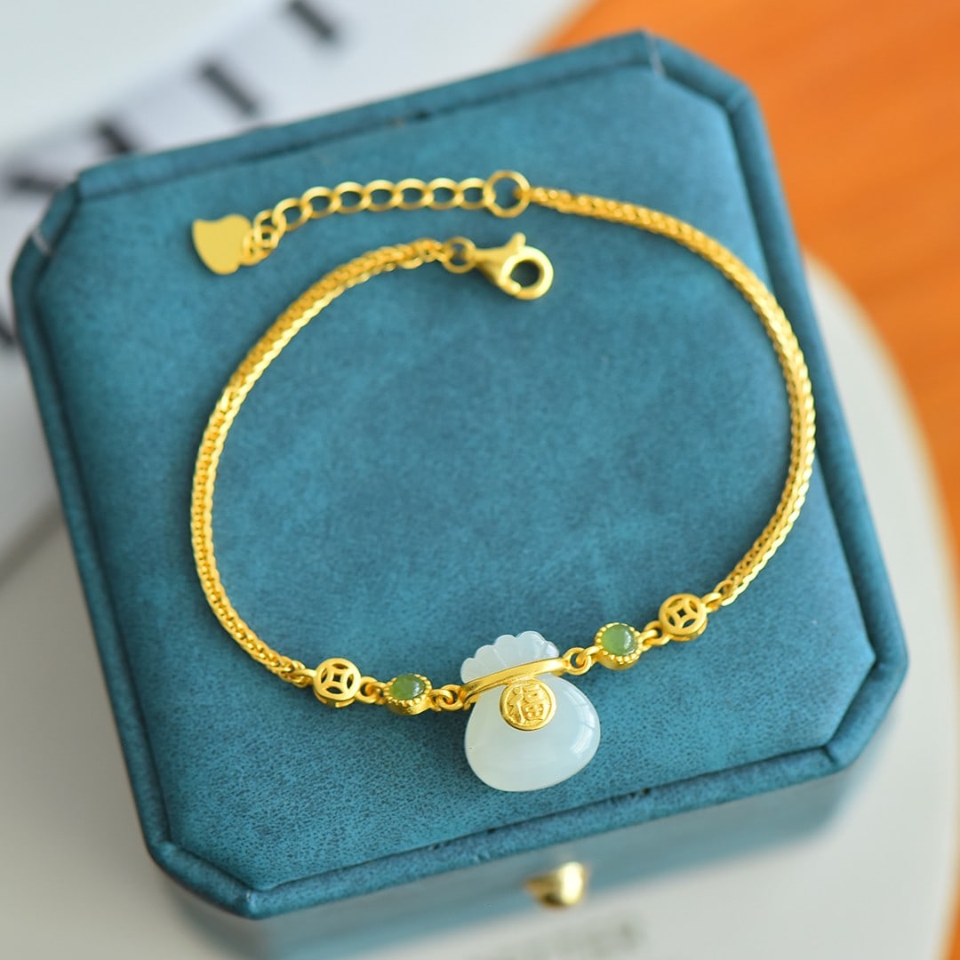 A Exquisite Silver Inlaid Hotan Jade Money Bag-shaped Bracelet: A Exquisite Silver Inlaid Hotan Jade Money Bag-shaped Bracelet,Size:0.5inx0.6in 银镶和田玉钱袋白加绿手链