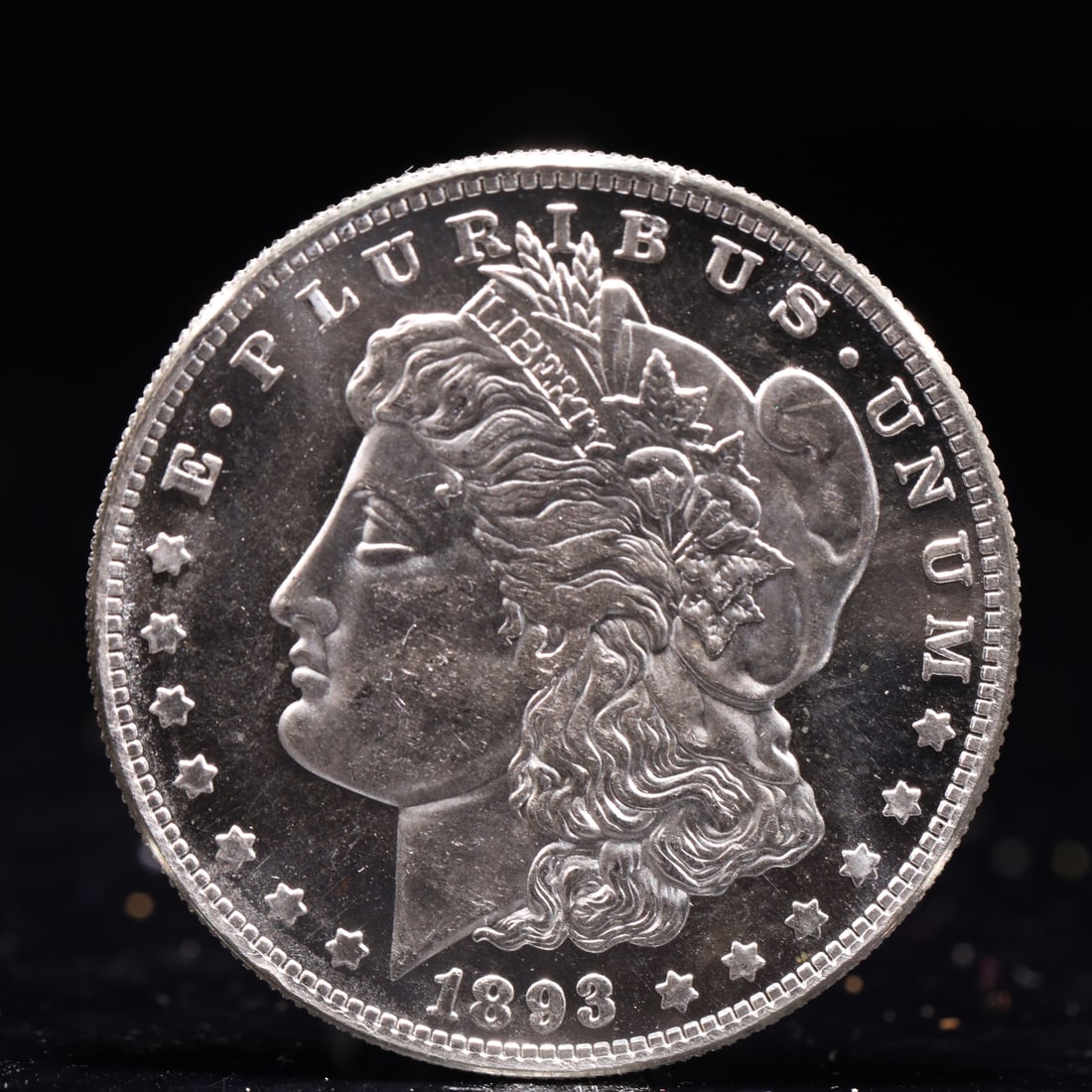 USA Morgan Dollar 1893 Coin: Obv: profile bust with date below and E PLURIBUS UNUM legend and stars around. Rev: eagle with In God we trust above within wreath with UNITED STATES OF AMERICA ONE DOLLAR legend. IN GOD WE TRUST / LI