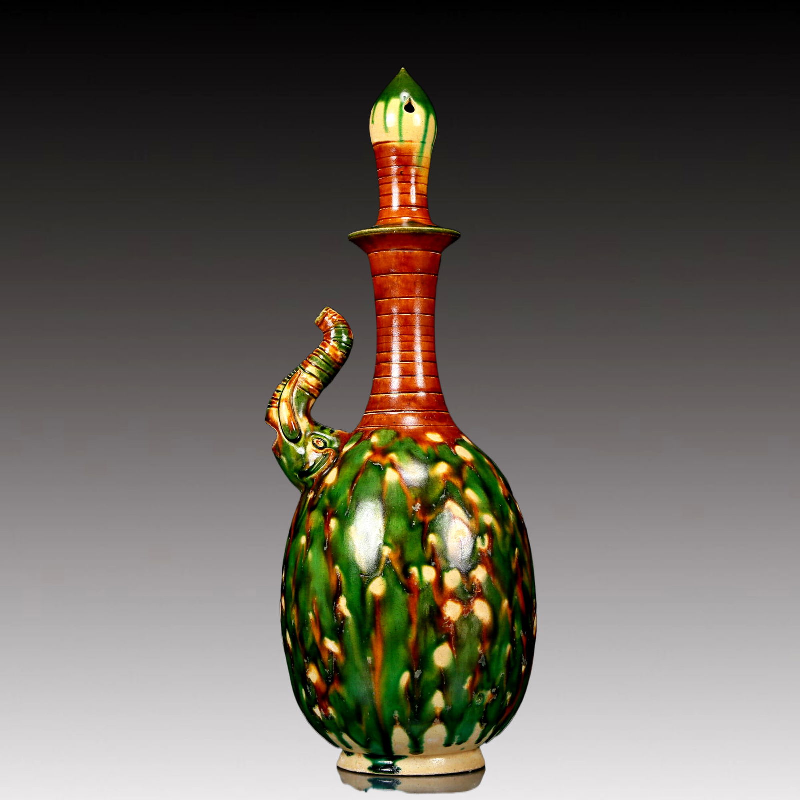 A Rare Tang Tri-Color Glazed Pottery Elephant Head Vase: A Rare Tang Tri-Color Glazed Pottery Elephant Head Vase,Tang Dynasty, China,Chinese Tang Tri-colored Pottery, or Tang Sancai, flourished during the Tang Dynasty (618–907 AD). It's renowned for i