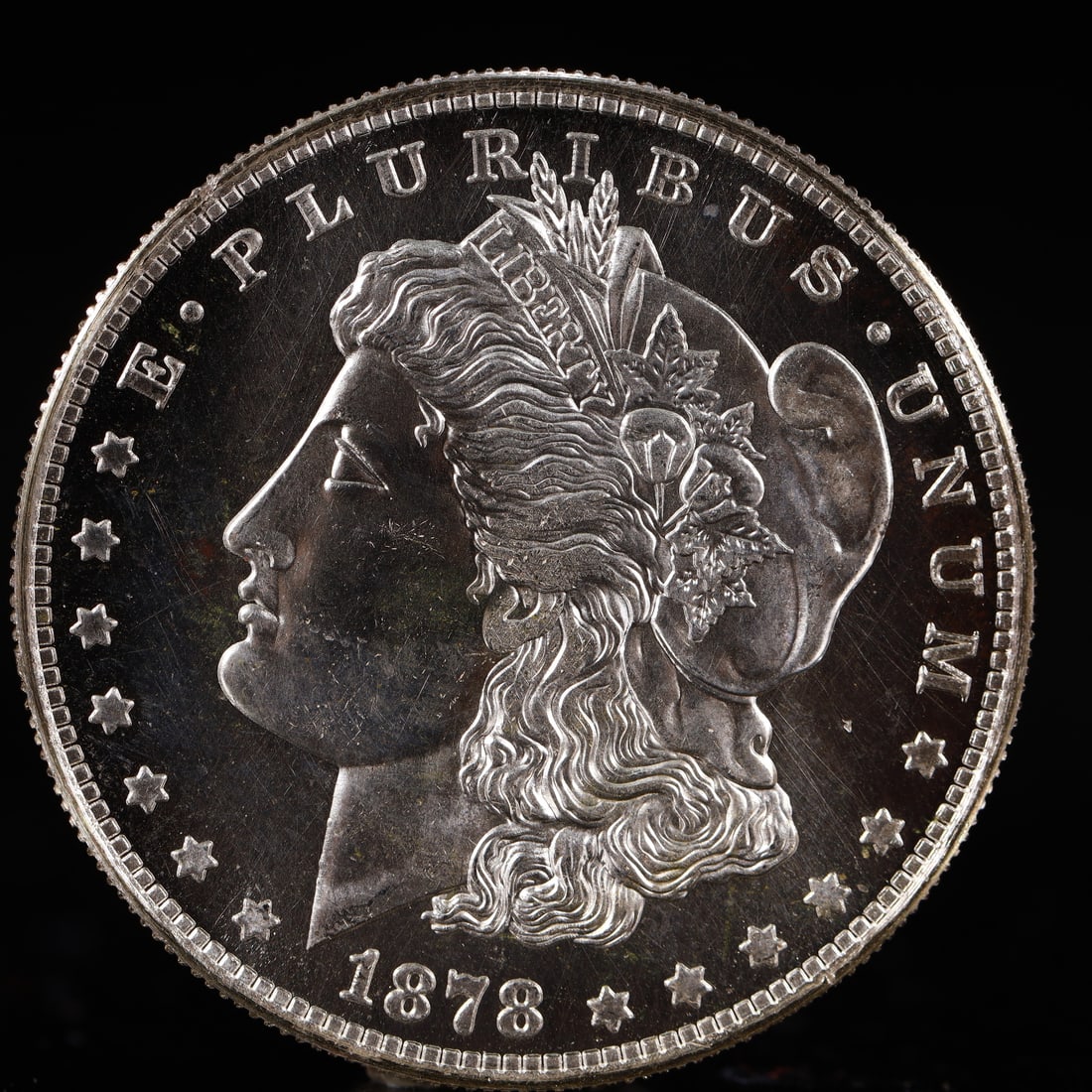 USA Morgan Dollar 1878 Coin: Obv: profile bust with date below and E PLURIBUS UNUM legend and stars around. Rev: eagle with In God we trust above within wreath with UNITED STATES OF AMERICA ONE DOLLAR legend. IN GOD WE TRUST /