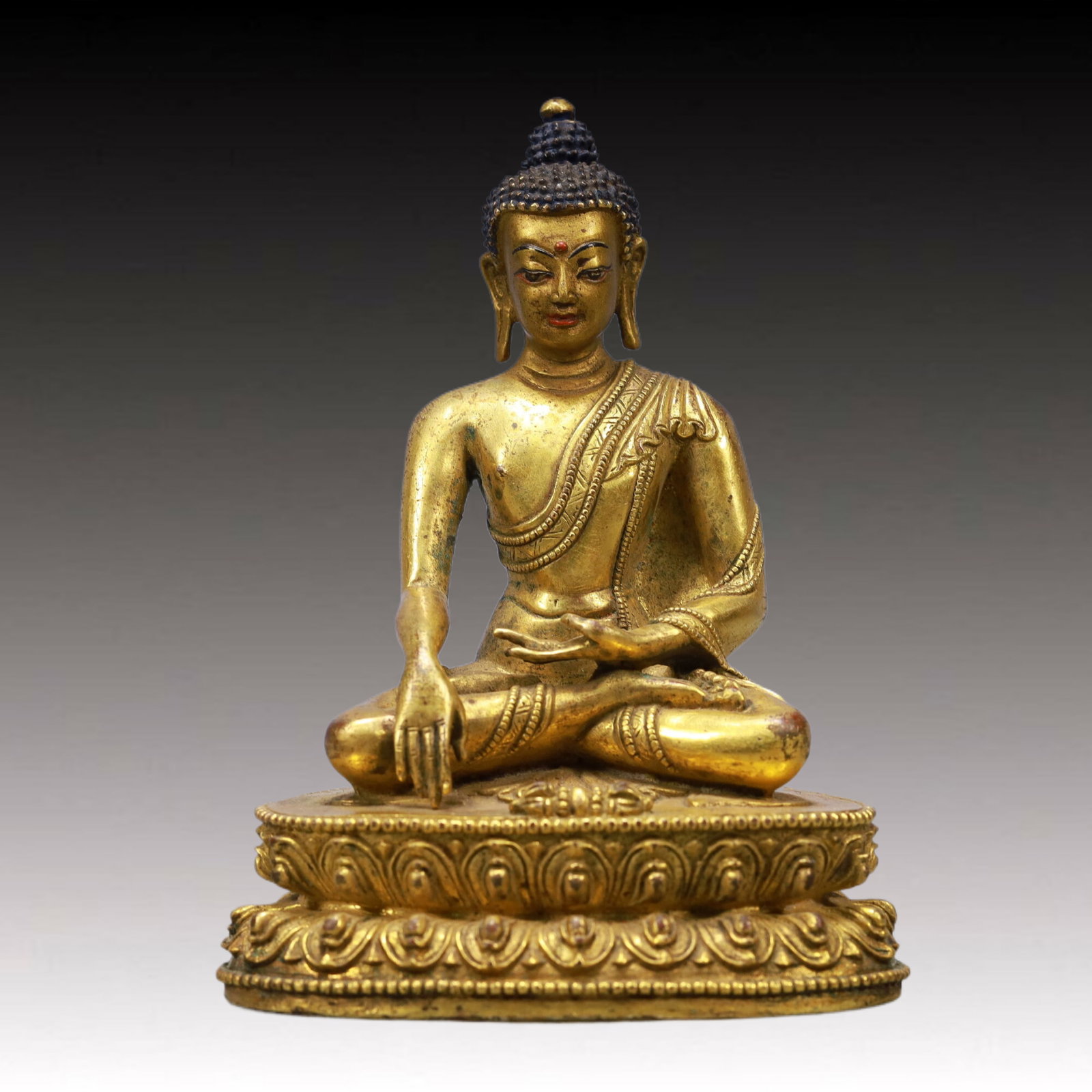 A Solemn Gilt Bronze Statue of Sakyamuni: A Solemn Gilt Bronze Statue of Sakyamuni,Qing Dynasty, China,Size:3.9inx2.8inx5.7inWeight:700g 铜鎏金释迦牟尼像,中国清代