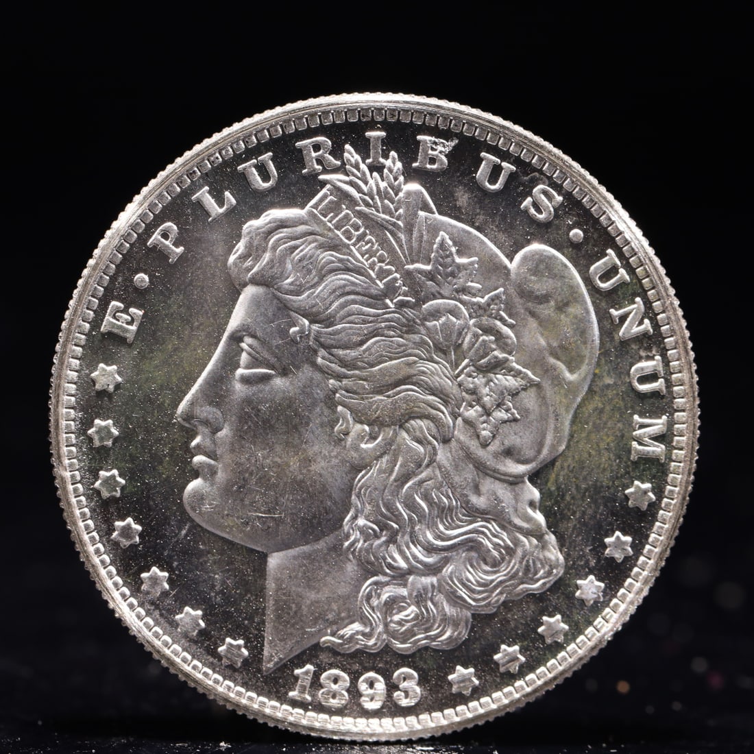 USA Morgan Dollar 1893 Coin: Obv: profile bust with date below and E PLURIBUS UNUM legend and stars around. Rev: eagle with In God we trust above within wreath with UNITED STATES OF AMERICA ONE DOLLAR legend. IN GOD WE TRUST /