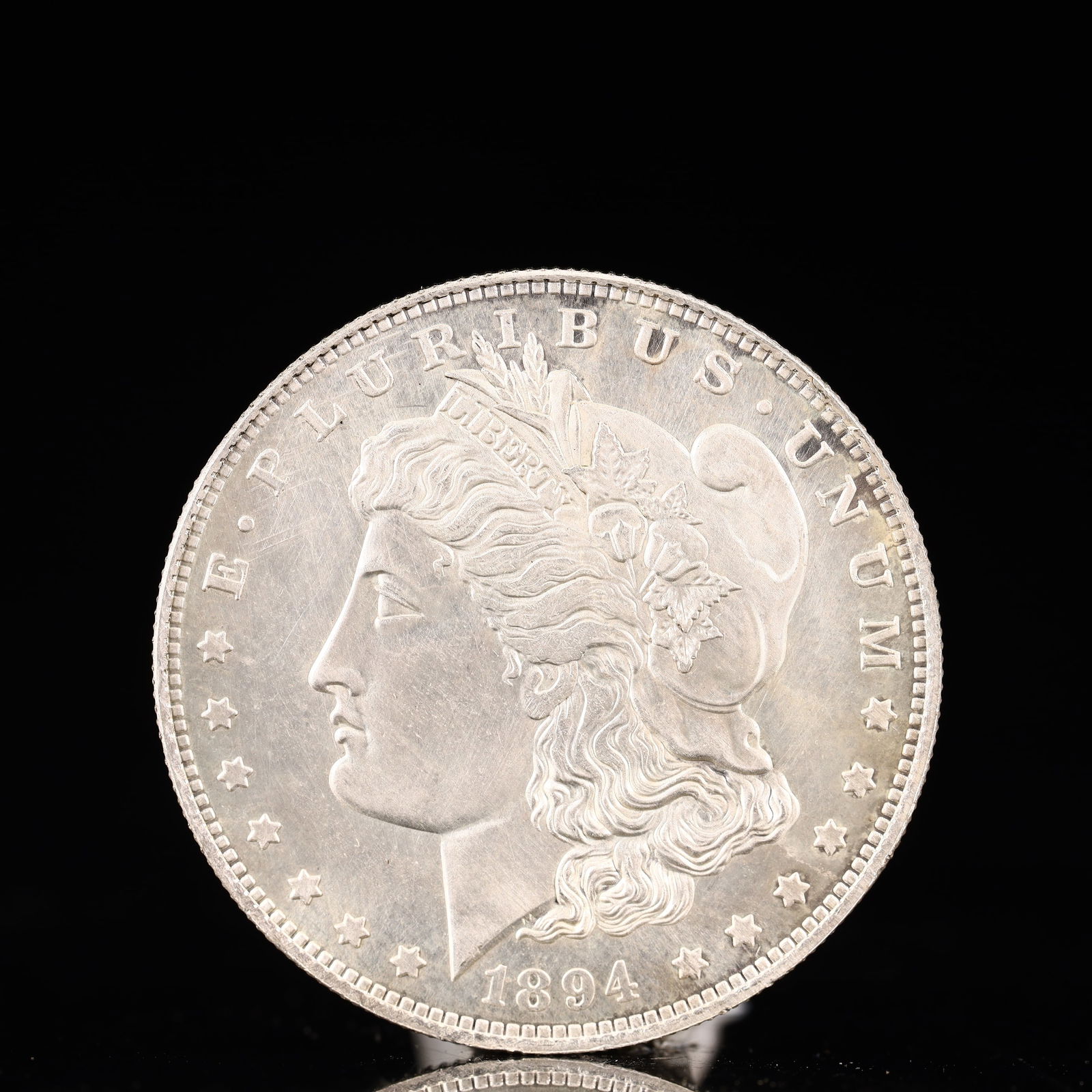 USA Morgan Dollar 1894 Coin: Obv: profile bust with date below and E PLURIBUS UNUM legend and stars around. Rev: eagle with In God we trust above within wreath with UNITED STATES OF AMERICA ONE DOLLAR legend. IN GOD WE TRUST /