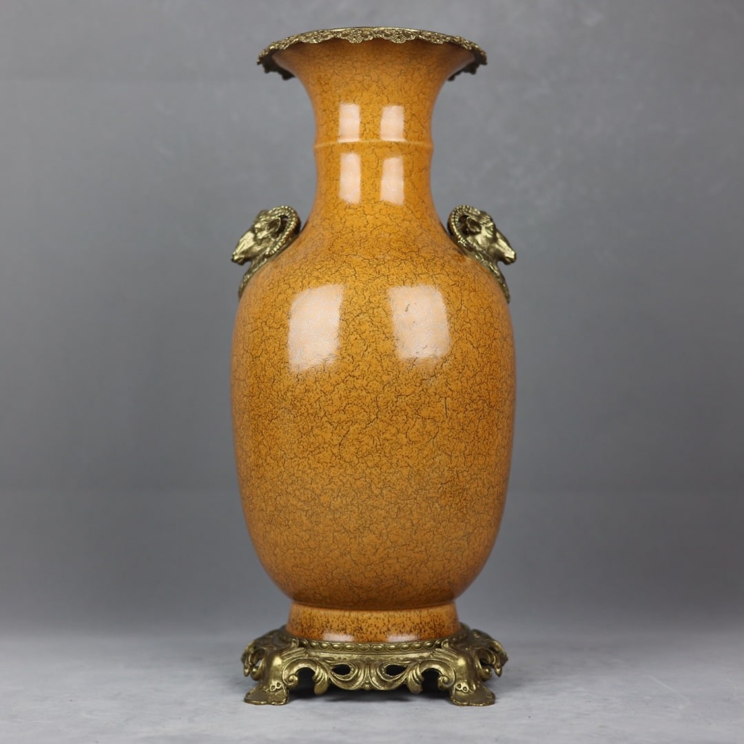 An Exquisite Yellow Glazed Inlaid Bronze Double-Ears Vase: An Exquisite Yellow Glazed Inlaid Bronze Double-Ears Vase Qing Dynasty, China Kangxi Six-character Mark Size:17.5inx7.5in鳝鱼黄釉开片羊首耳赏