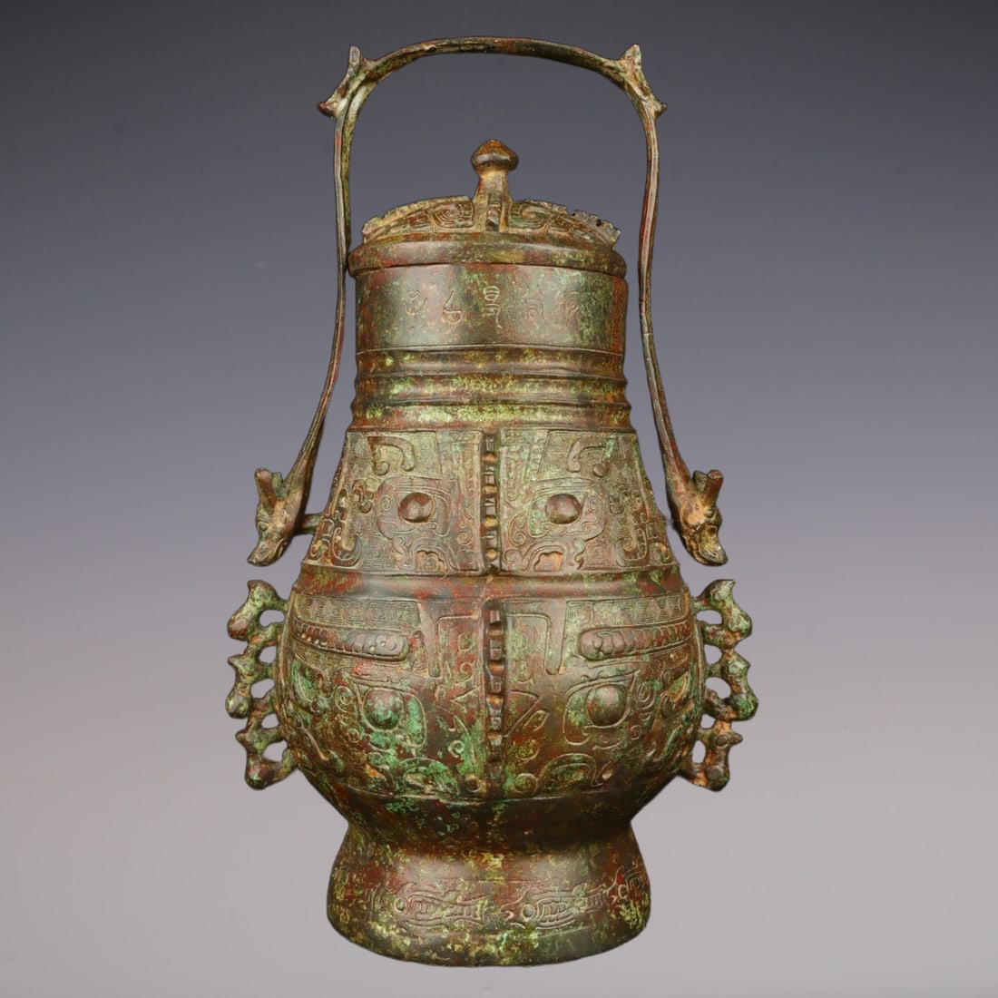 An Exquisite Bronze Beast-Face Pattern With Inscription Ewer: An Exquisite Bronze Beast-Face Pattern With Inscription Ewer W.Zhou , China Size:7.1inx10.2in Weight:2350g青铜兽面纹提梁 西周时期