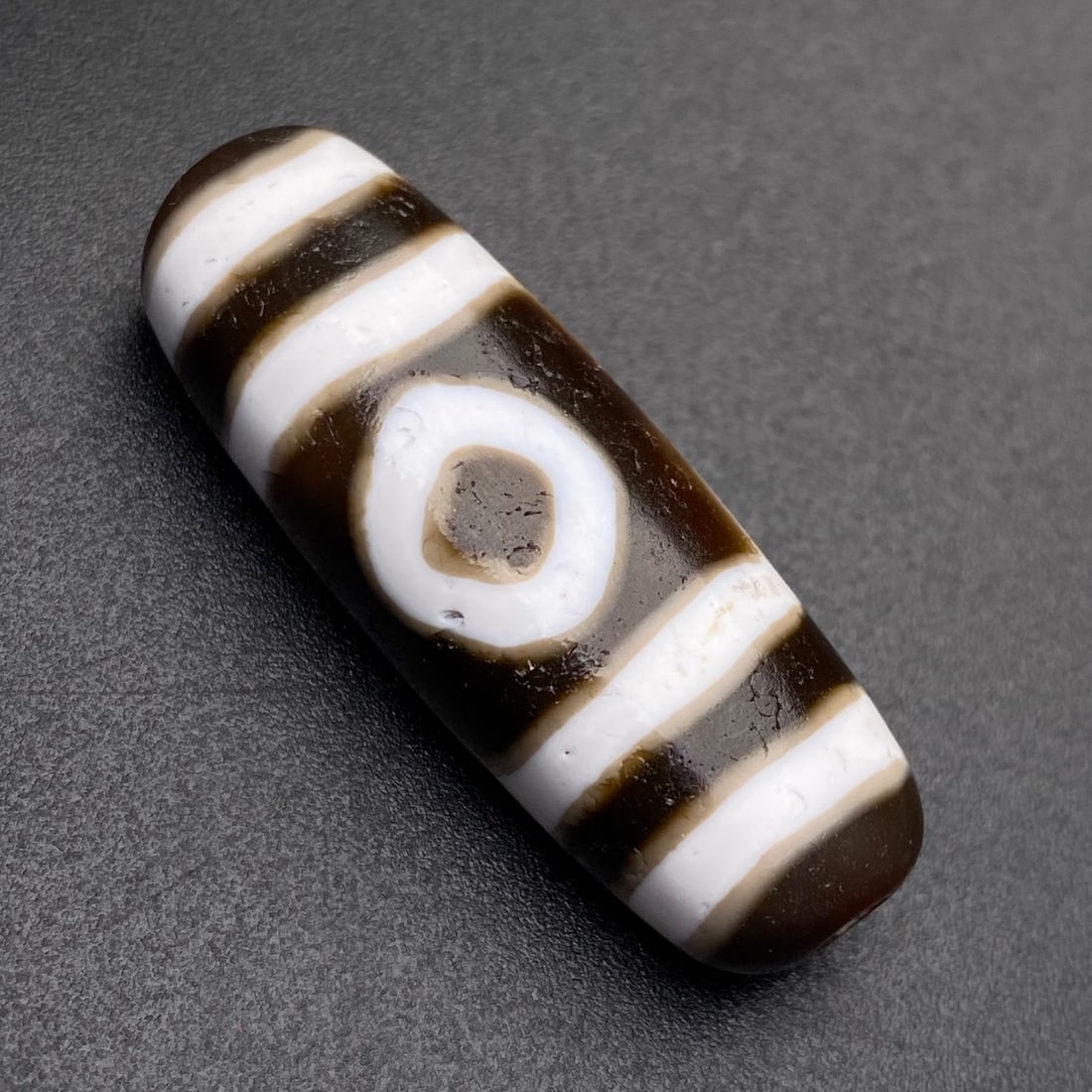 An Exquisite Three Eyes Dzi Bead Pendant: An Exquisite Three Eyes Dzi Bead Pendant,Size:36mmx12mmx10mm,Weight:7.6g 三眼天珠挂件