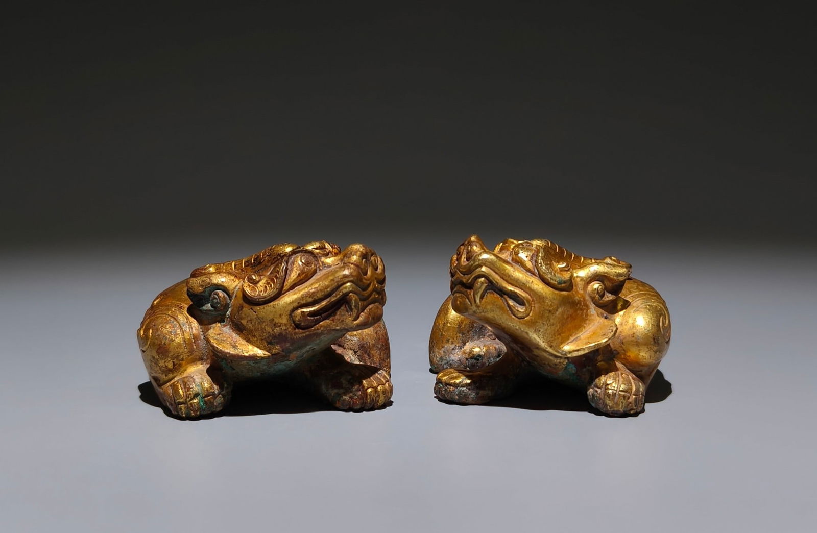 A Pair of Exquisite Gilt Bronze Auspicious Beast Ornaments: A Pair of Exquisite Gilt Bronze Auspicious Beast Ornaments,the Warring States period in China,Size:1.8inx3.7inx2.6in 