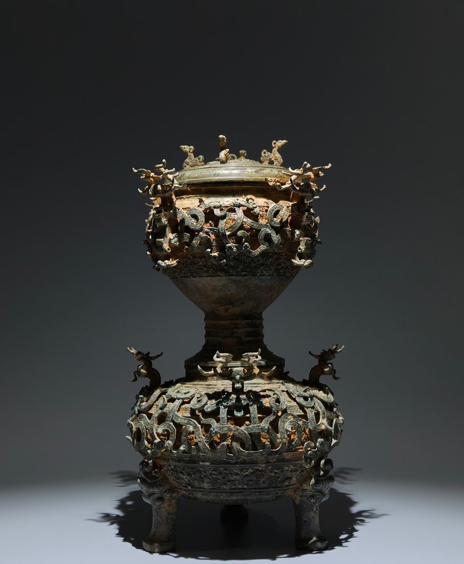 An Archaic Bronze Coiled-Dragon Pattern Tripod Food vessel,With Base,With Inscription: An Archaic Bronze Coiled-Dragon Pattern Tripod Food vessel,With Base,With Inscription,the Warring States period in China,Size:16.5inx8.7in 青铜蟠龙纹三足Ƈ