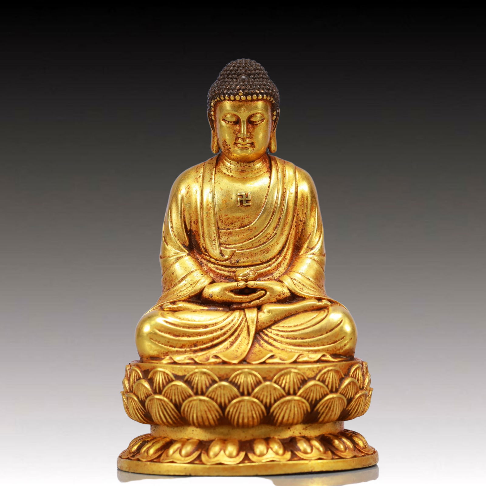A Solemn Gilt Bronze Statue of Sakyamuni: A Solemn Gilt Bronze Statue of Sakyamuni,Ming Dynasty, China,Yongle Six-character Mark,Size:2.4inx2inx3.5in,Weight:608g 