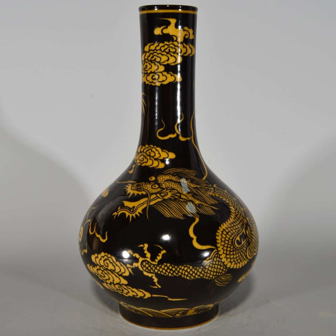 An Exquisite Black Ground Yellow Color Auspicious Cloud and Dragon Pattern Vase: An Exquisite Black Ground Yellow Color Auspicious Cloud and Dragon Pattern Vase,Qing Dynasty, China,Kangxi Six-character Mark,Size:10.4inx6.3in 黑地黄彩祥云龙