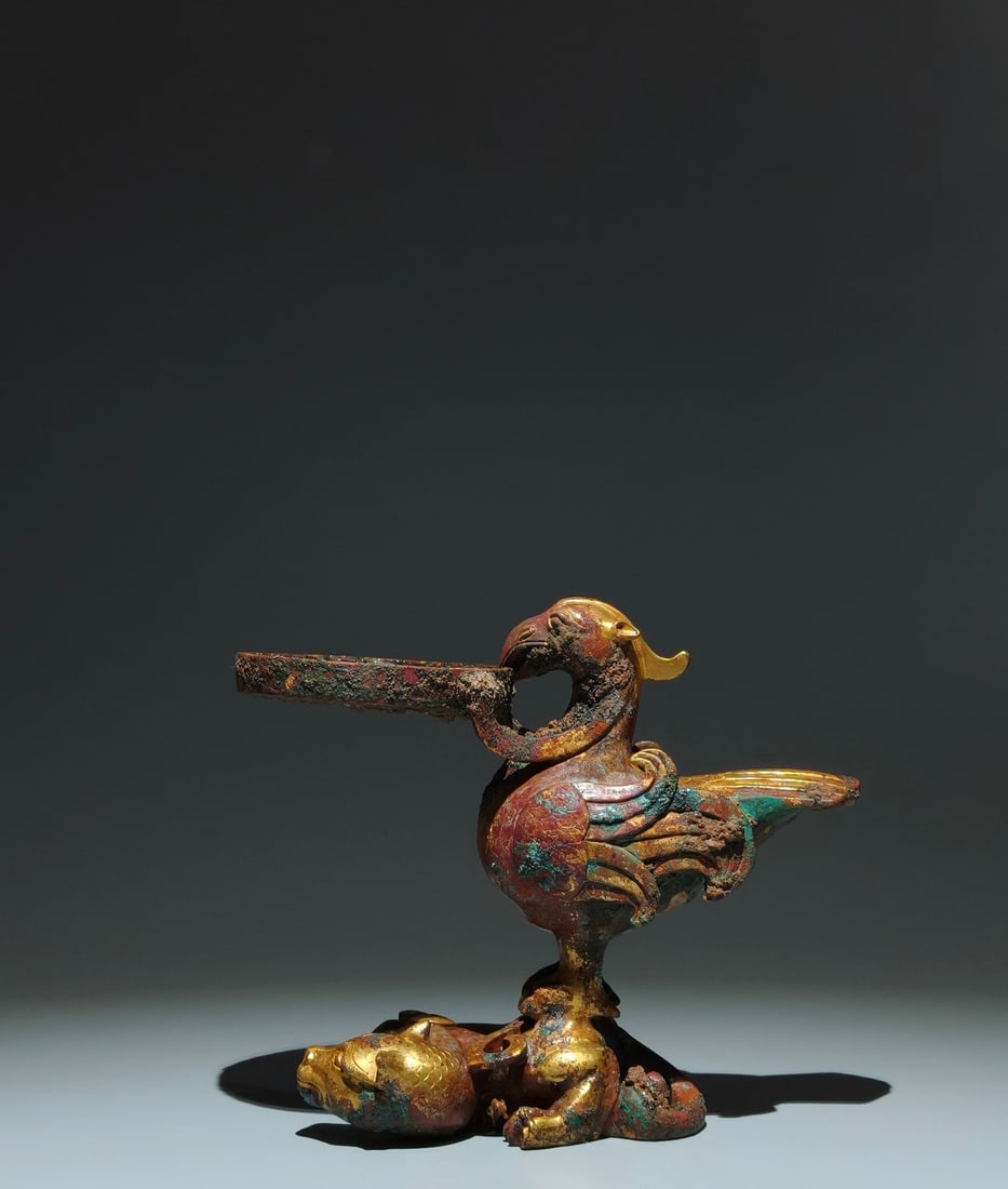 An Exquisite Gilt Bronze Dragon Pattern Phoenix-Shaped Candlestick: An Exquisite Gilt Bronze Dragon Pattern Phoenix-Shaped Candlestick,Han Dynasty,China,Size:6.7inx7.9inx3.9in 铜鎏金龙纹凤形烛台,中国