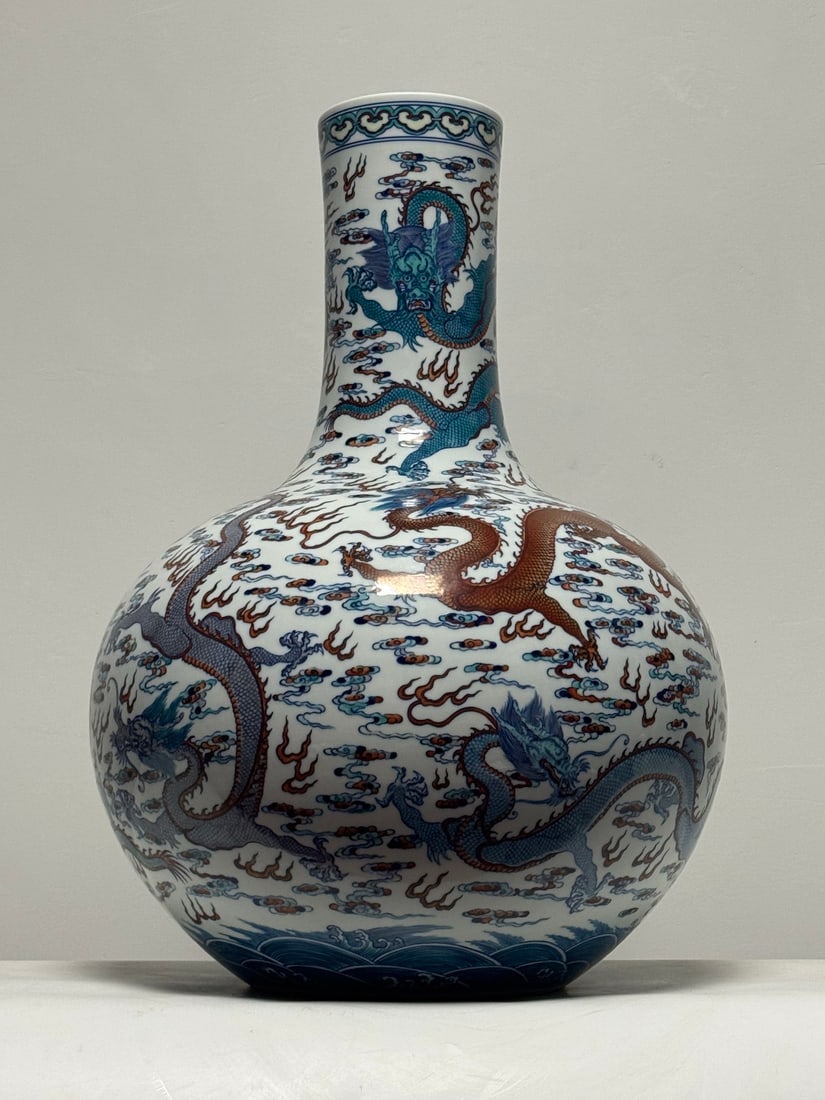 A Huge Doucai Seawater Auspicious Cloud and Dragon Pattern Vase: A Huge Doucai Seawater Auspicious Cloud and Dragon Pattern Vase,Qing Dynasty,China,Qianlong Six-character Mark,Size:22.8inx16.9in 斗彩海水祥云龙纹ல