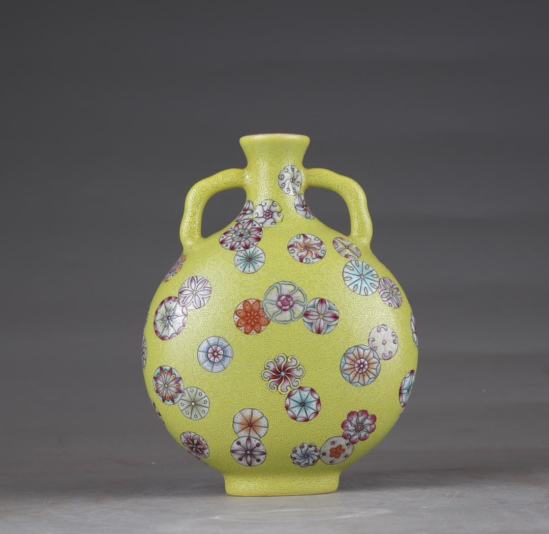 An Exquisite Yellow Ground Famille-Rose Flower Pattern Double-Ears Vase: An Exquisite Yellow Ground Famille-Rose Flower Pattern Double-Ears Vase,Qing Dynasty,China,Qianlong Six-character Mark,Size:6.7inx5.1in 黄地粉彩花卉纹双