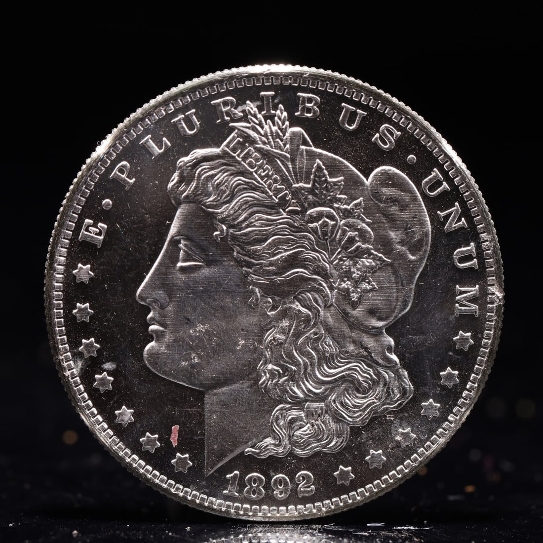 USA Morgan Dollar 1892 Coin: Obv: profile bust with date below and E PLURIBUS UNUM legend and stars around. Rev: eagle with In God we trust above within wreath with UNITED STATES OF AMERICA ONE DOLLAR legend. IN GOD WE TRUST /