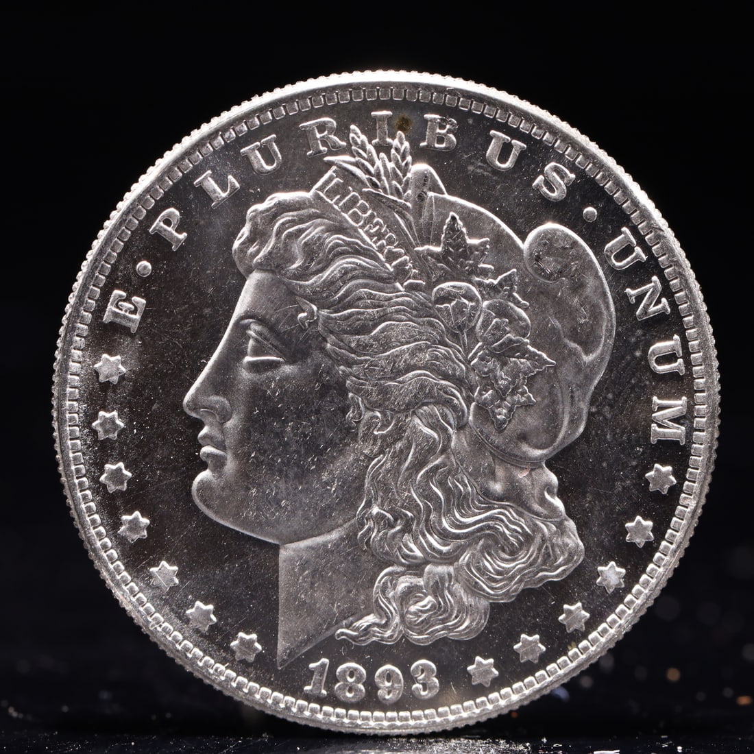 USA Morgan Dollar 1893 Coin: Obv: profile bust with date below and E PLURIBUS UNUM legend and stars around. Rev: eagle with In God we trust above within wreath with UNITED STATES OF AMERICA ONE DOLLAR legend. IN GOD WE TRUST / LI