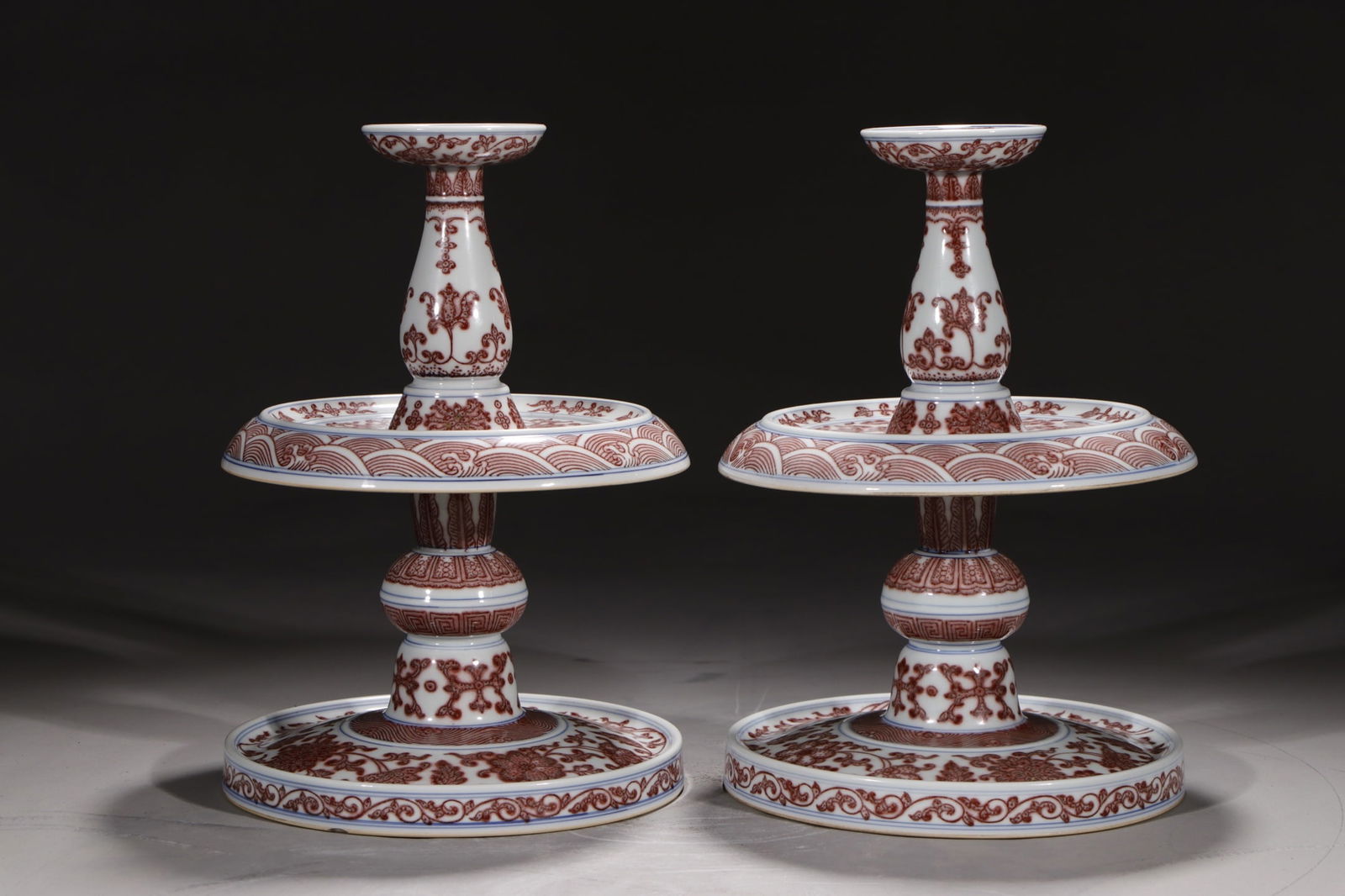 A Pair of Exquisite Underglaze-Red Lotus Pattern Candlesticks: A Pair of Exquisite Underglaze-Red Lotus Pattern Candlesticks,Qing Dynasty,China,Qianlong Six-character Mark,Size:10.8in 