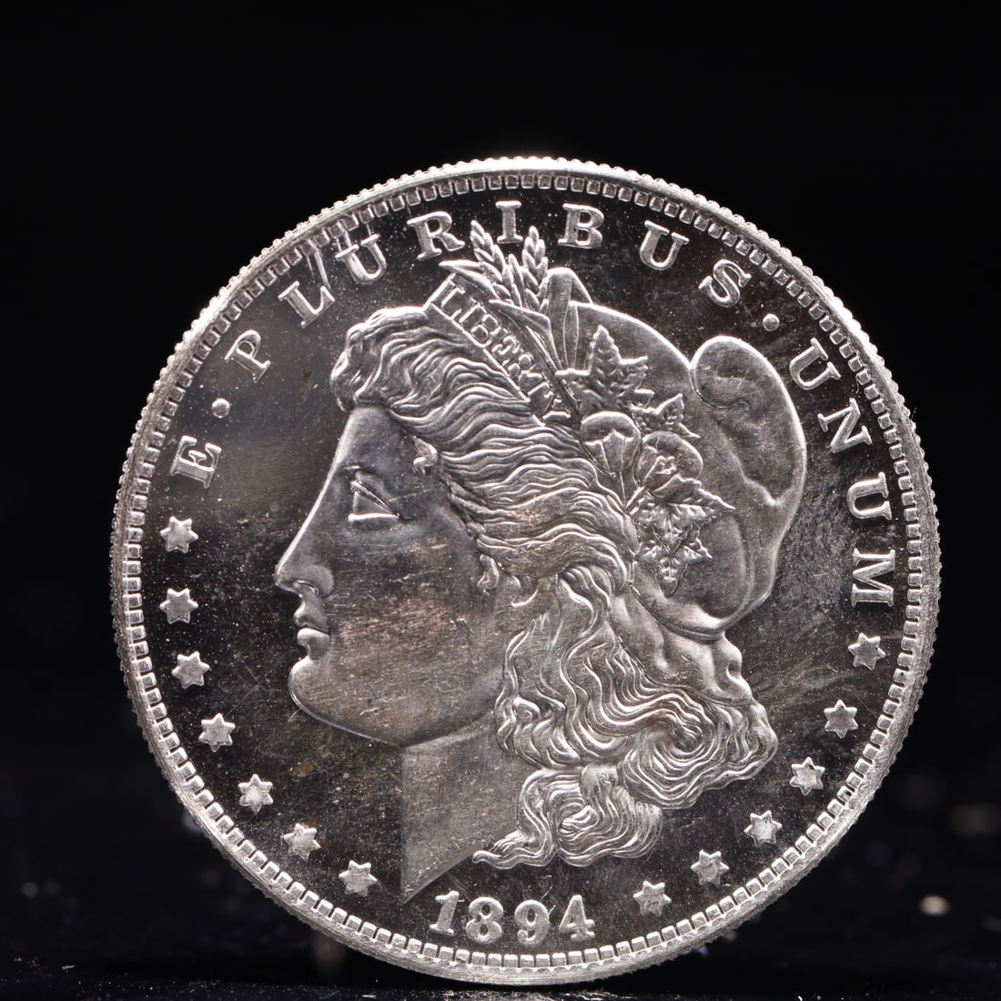USA Morgan Dollar 1894 Coin: Obv: profile bust with date below and E PLURIBUS UNUM legend and stars around. Rev: eagle with In God we trust above within wreath with UNITED STATES OF AMERICA ONE DOLLAR legend. IN GOD WE TRUST / LI