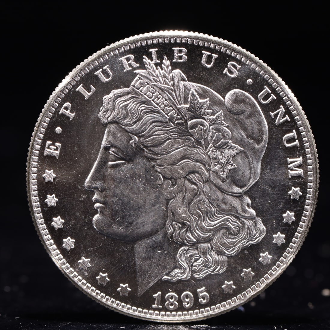 USA Morgan Dollar 1895 Coin: Obv: profile bust with date below and E PLURIBUS UNUM legend and stars around. Rev: eagle with In God we trust above within wreath with UNITED STATES OF AMERICA ONE DOLLAR legend. IN GOD WE TRUST /