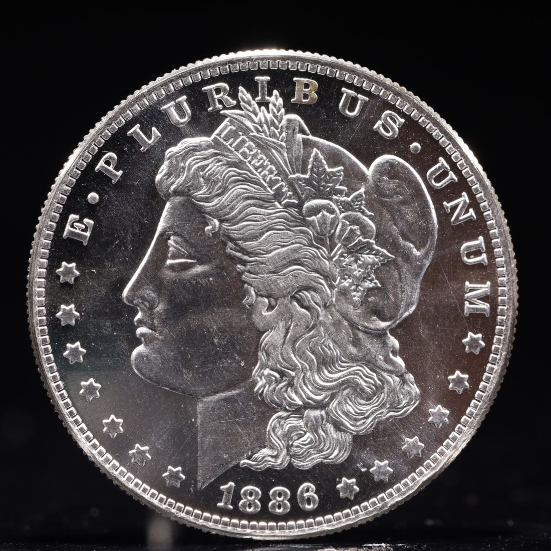 USA Morgan Dollar 1886 Coin: Obv: profile bust with date below and E PLURIBUS UNUM legend and stars around. Rev: eagle with In God we trust above within wreath with UNITED STATES OF AMERICA ONE DOLLAR legend. IN GOD WE TRUST /