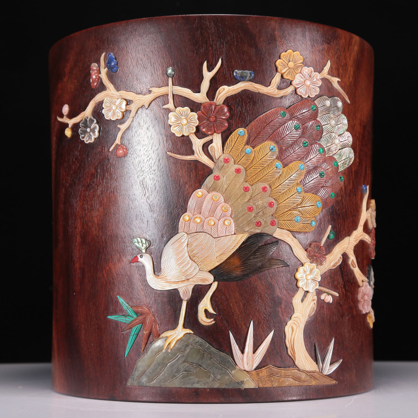 An Exquisite Huanghuali Gem-Inlaid 'Peacock& Flower' Brush Pot With Poem Inscriptions: An Exquisite Huanghuali Gem-Inlaid 'Peacock& Flower' Brush Pot With Poem Inscriptions. Of a cylindrical shape, the exterior enameled and inlaid in polychrome with flowers and a peacock with fine,