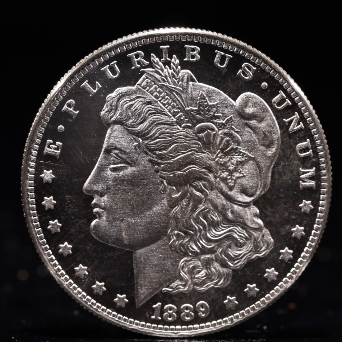 USA Morgan Dollar 1889 Coin: Obv: profile bust with date below and E PLURIBUS UNUM legend and stars around. Rev: eagle with In God we trust above within wreath with UNITED STATES OF AMERICA ONE DOLLAR legend. IN GOD WE TRUST /