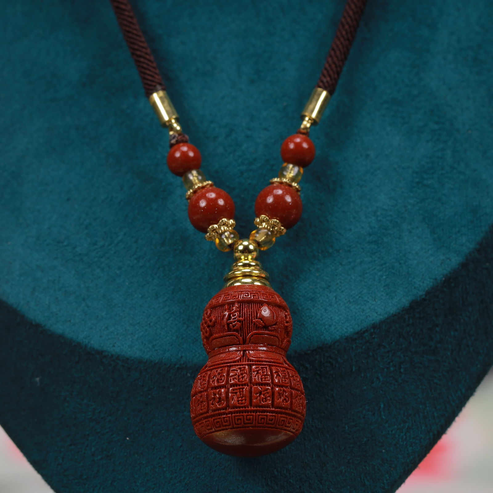 An Exquisite Cinnabar Gourd-Shaped Pendant: An Exquisite Cinnabar Gourd-Shaped Pendant, Size:0.8inx1.6in, Weight:29g 朱砂葫芦形挂件