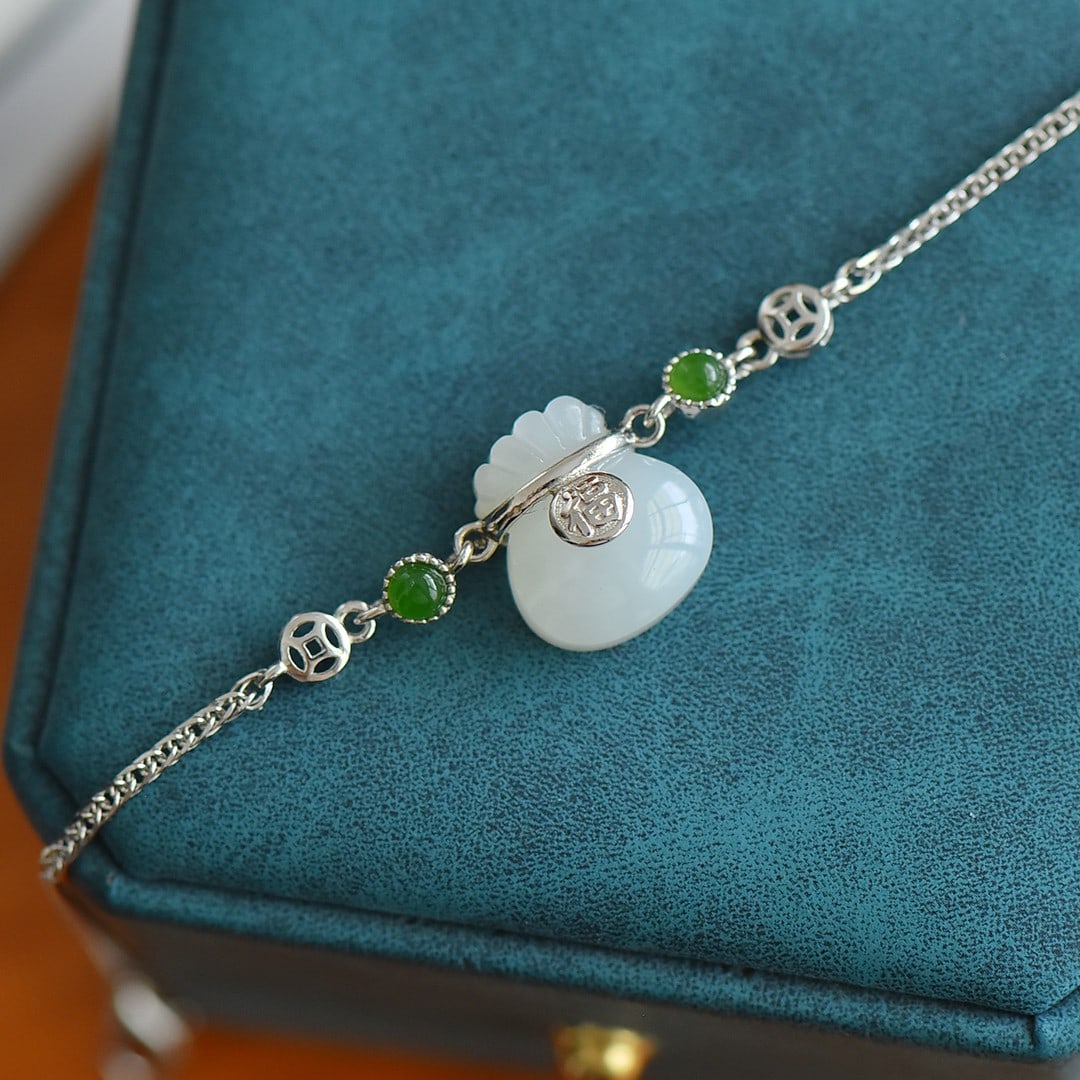 A Exquisite Silver Inlaid Hotan Jade Money Bag-shaped Bracelet: A Exquisite Silver Inlaid Hotan Jade Money Bag-shaped Bracelet,Size:0.5inx0.6in 银镶和田玉福袋手链