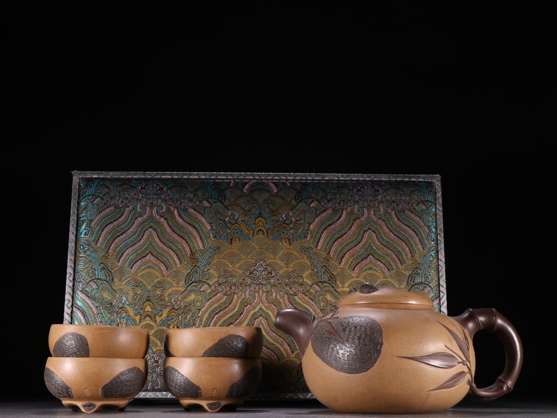 A Set of Fine Purple Sands Bamboo Pattern Teapot: A Set of Fine Purple Sands Bamboo Pattern Teapot Qing Dynasty, China Size:3.7inx6.9in Size:1inx2.7in紫砂熊猫纹套壶 中国清代 Size:9.5cm