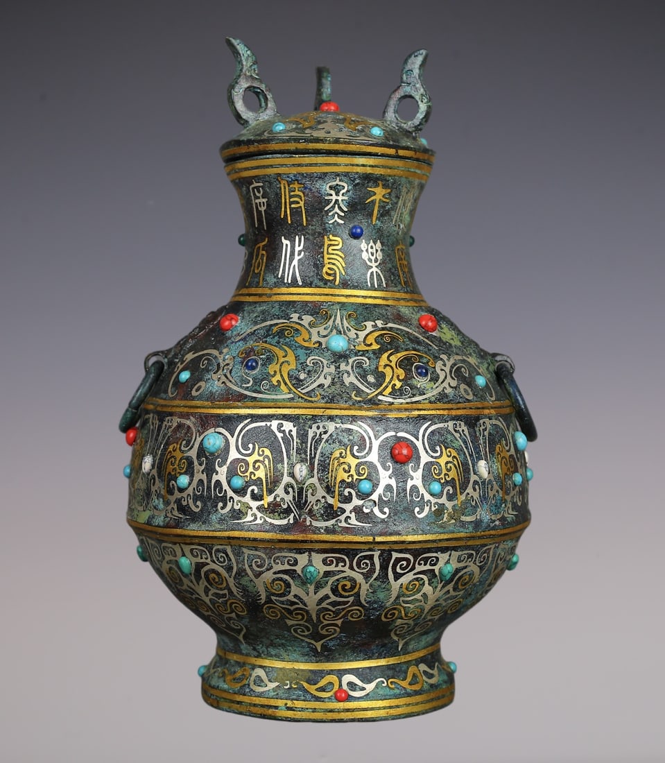 An Exquisite Bronze Inlaid Gold Inlaid Gems With Inscription Double-Ears Vase: An Exquisite Bronze Inlaid Gold Inlaid Gems With Inscription Double-Ears Vase Han Dynasty, China Size:6.3inx6.3inx10.6in Weight:1730g青铜错金镶嵌圆瓶 &#