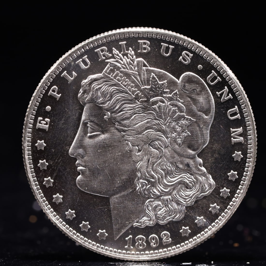 USA Morgan Dollar 1892 Coin: Obv: profile bust with date below and E PLURIBUS UNUM legend and stars around. Rev: eagle with In God we trust above within wreath with UNITED STATES OF AMERICA ONE DOLLAR legend. IN GOD WE TRUST /