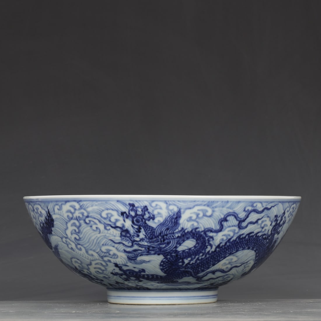 An Exquisite Blue and White Seawater and Dragon Pattern Bowl: An Exquisite Blue and White Seawater and Dragon Pattern Bowl,Ming Dynasty,China,Xuande Six-character Mark,Size:3.9inx10.2in 青花海水龙纹碗,中国