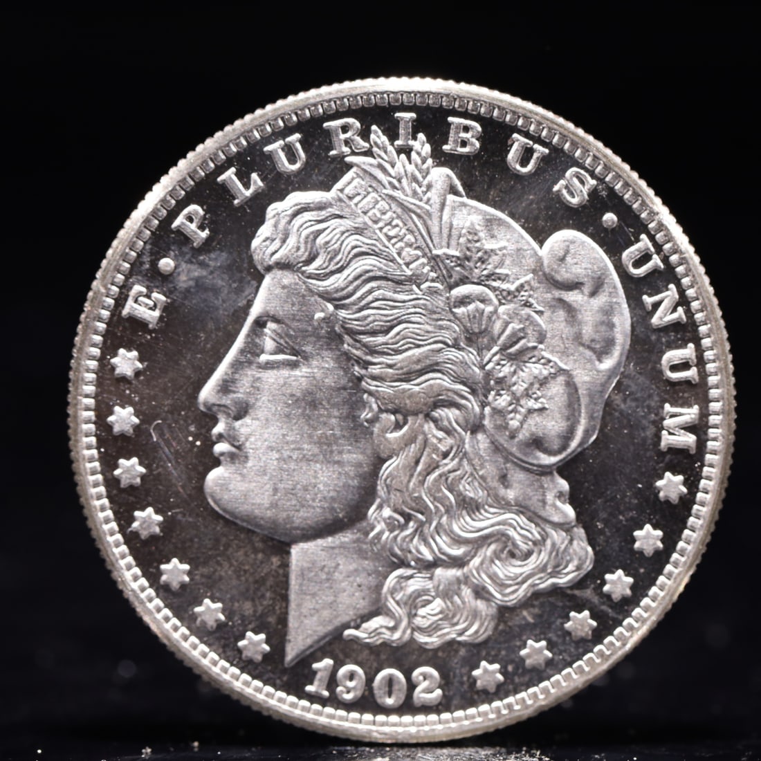 USA Morgan Dollar 1902 Coin: Obv: profile bust with date below and E PLURIBUS UNUM legend and stars around. Rev: eagle with In God we trust above within wreath with UNITED STATES OF AMERICA ONE DOLLAR legend. IN GOD WE TRUST / LI