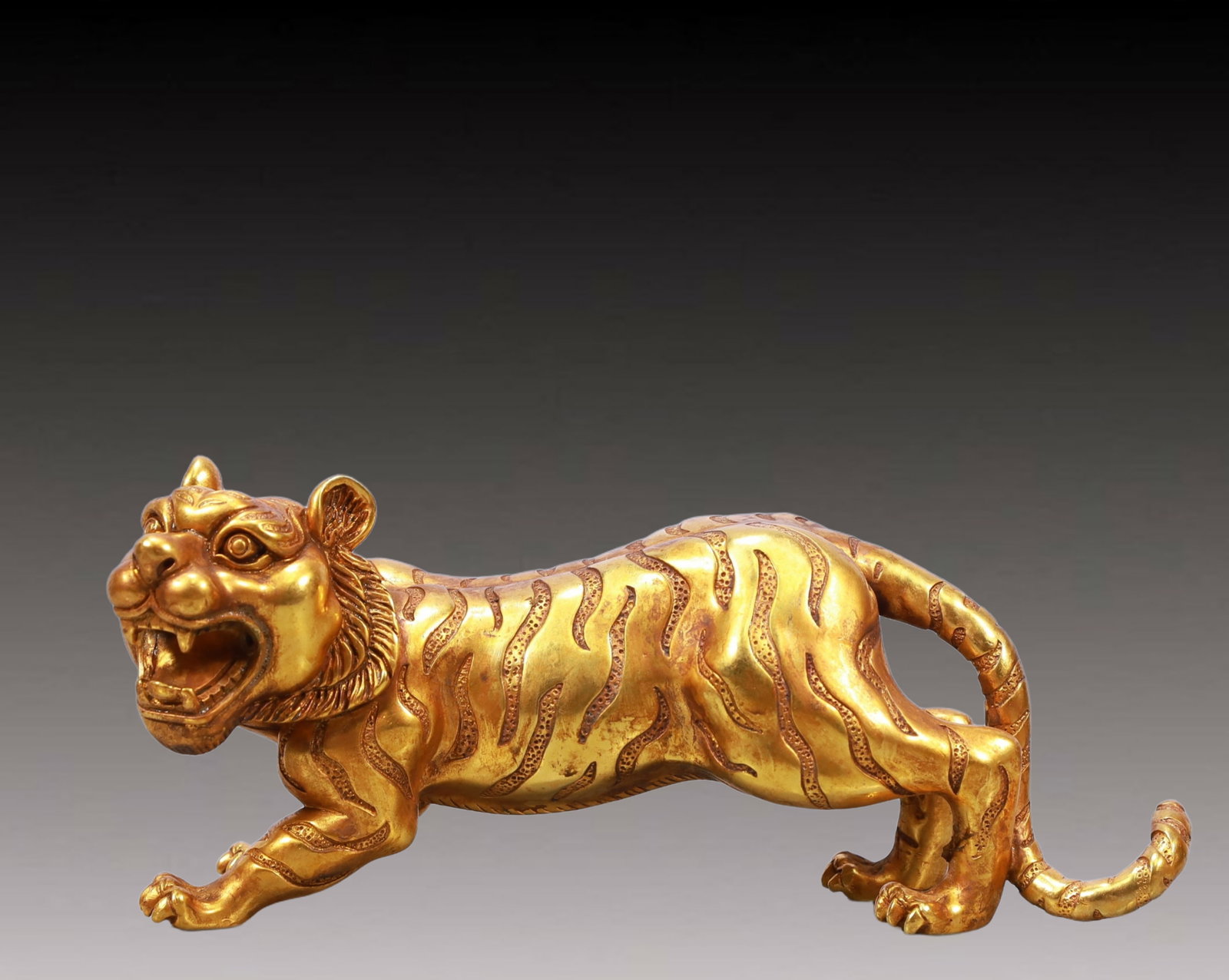 A Rare Gilt Bronze Tiger Ornament: A Rare Gilt Bronze Tiger Ornament,Tang Dynasty, China,Size:9.1inx2.8inx4.3in,Weight:1950g 铜鎏金老虎摆件,中国唐代