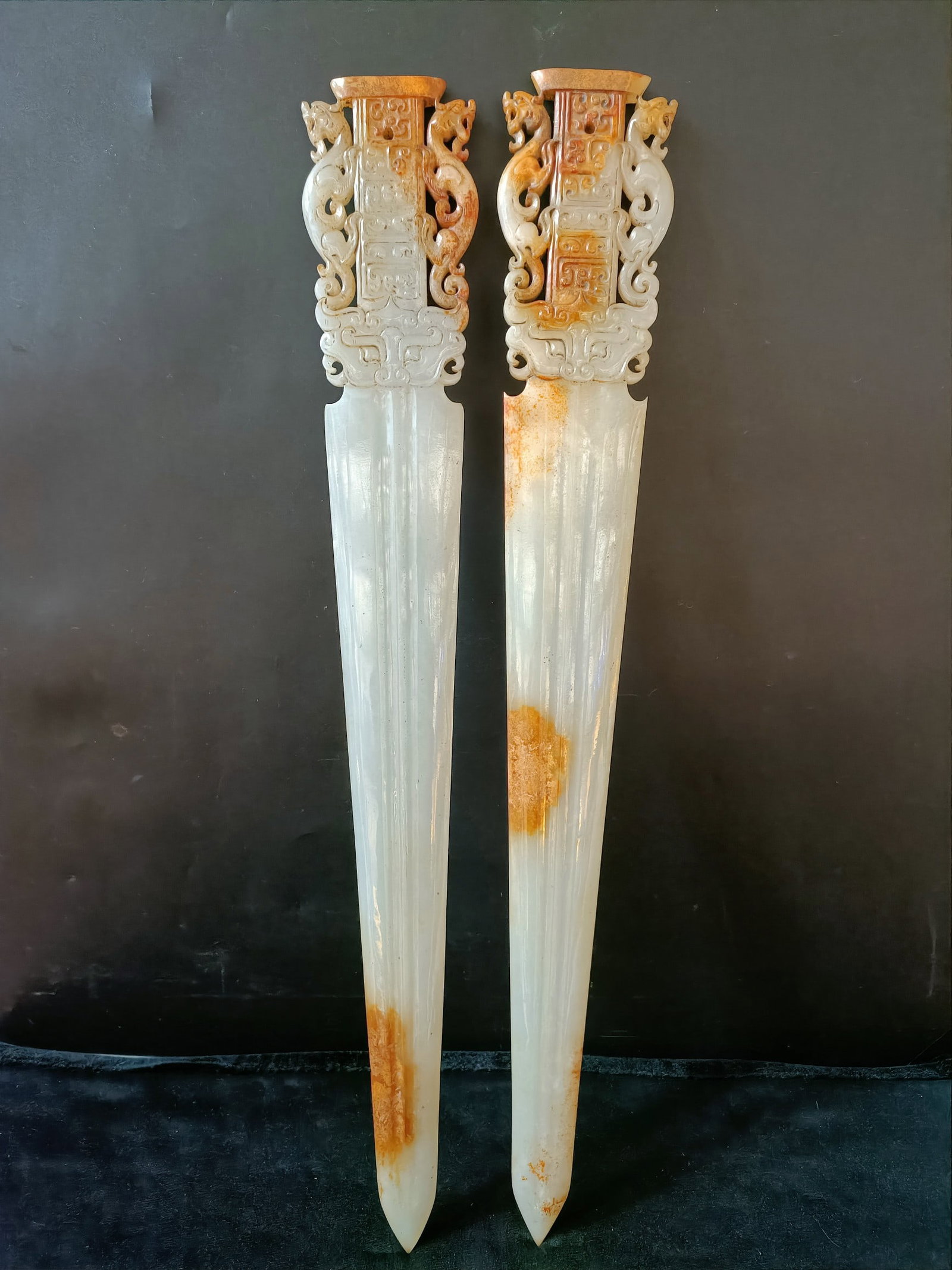 A pair of Exquisite Hotan Sword Heads: A pair of Exquisite Hotan Sword Heads,Han Dynasty, China,Size:0.5inx2.8inx19.9in,Weight:513g 一对和田玉剑头,中国汉代