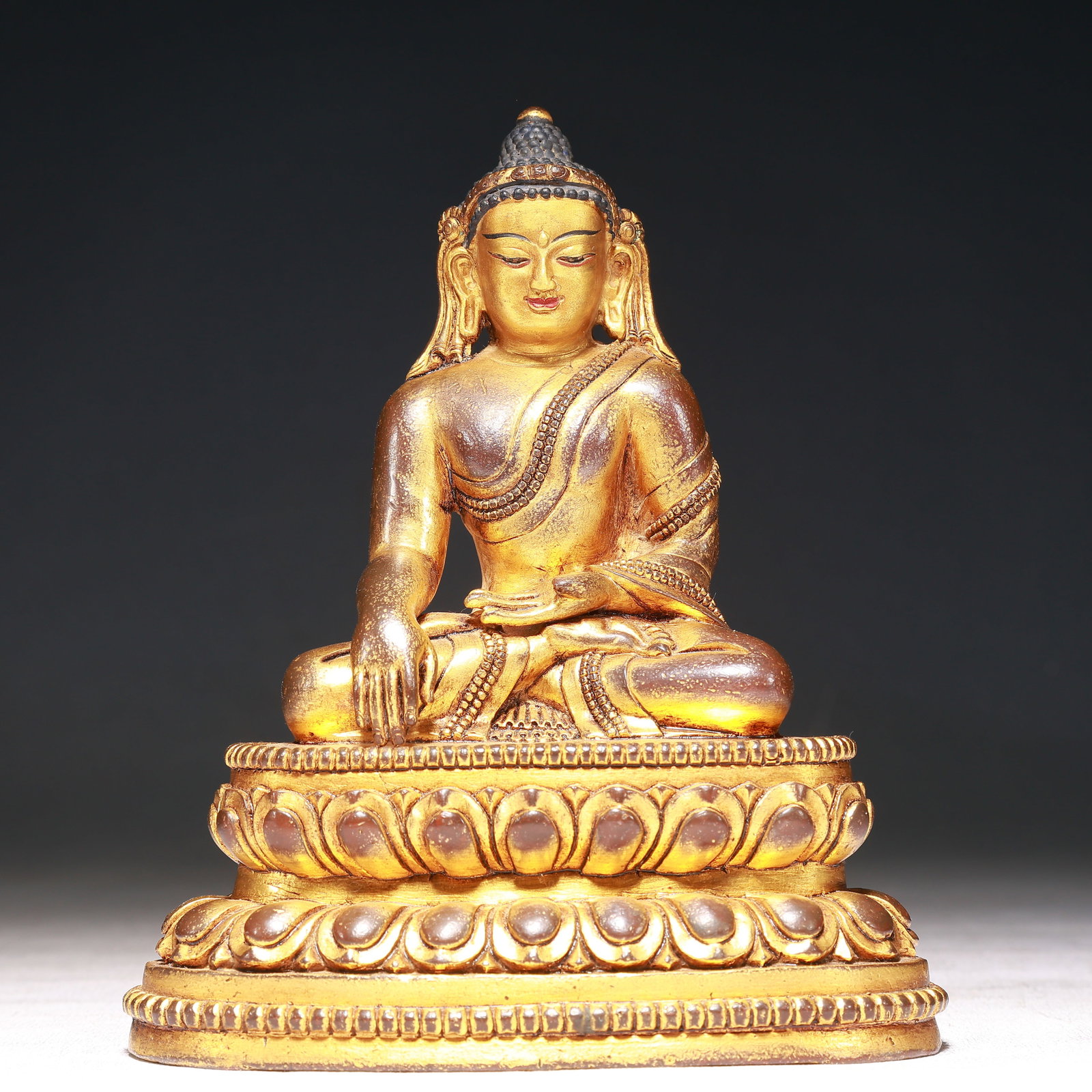 A Solemn Gilt Bronze Statue of Sakyamuni: A Solemn Gilt Bronze Statue of Sakyamuni,Qing Dynasty,China,Size:5.1inx2.8inx6.3in,Weight:1000g 铜鎏金释迦摩尼像,中国清代