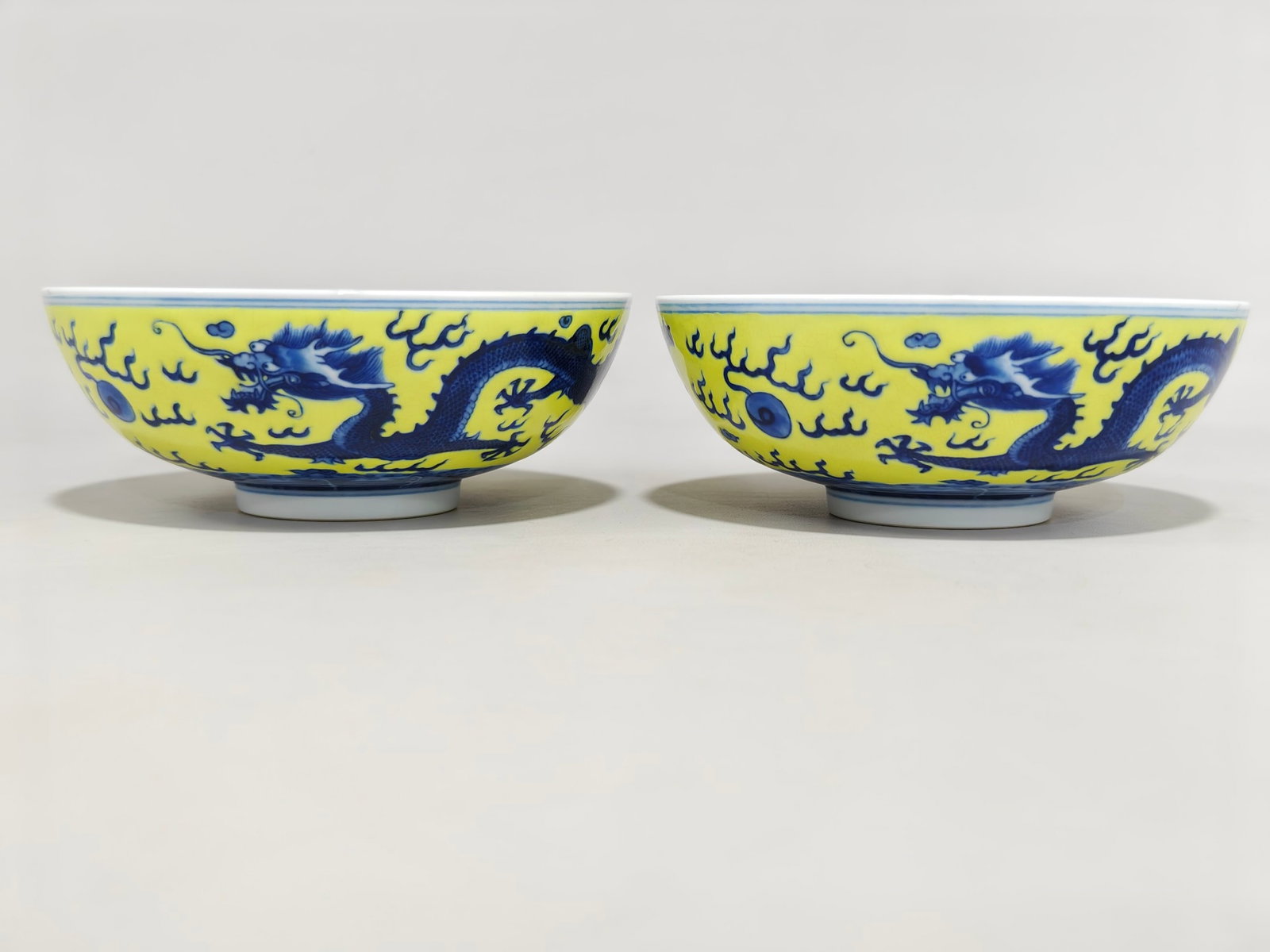 A Pair of Exquisite Blue and White Yellow Ground Dragon Pattern Bowls: A Pair of Exquisite Blue and White Yellow Ground Dragon Pattern Bowls,Qing Dynasty,China,Guangxu Six-character Mark,Size:2.2inx5.6in 