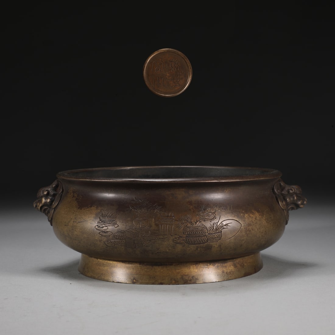 An Exquisite Bronze Flower Pattern Double-Ears Censer: An Exquisite Bronze Flower Pattern Double-Ears Censer Ming Dynasty, China Size:2.7inx6.8in Weight:1650g铜狮首耳炉 中国明代 Size:6.8cmx17.2cm Weigh